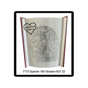 May include: A book with pages folded to create a detailed image of a Spaniel dog. The book is open, revealing the dog's silhouette in the center. The text "JHBookFold Patterns" is in a heart-shaped logo. The text "7173 Spaniel 180 Shadow 637 23" is at the bottom.