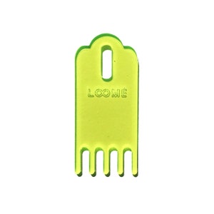 May include: A lime green plastic loom hook with a handle and five prongs. The hook has the word "LOOME" printed on it.