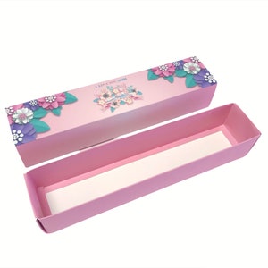 May include: Pink cardboard box with a floral design and the text "I Love You Mom". The box is open and the inside is lined with white paper.