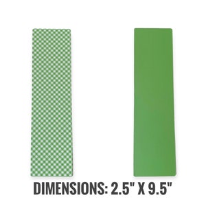 May include: Two rectangular bookmarks. One has a green and white gingham pattern, the other is solid green. The text "DIMENSIONS: 2.5" X 9.5"" is printed at the bottom. These bookmarks are ideal for books and journals.