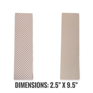 May include: Two rectangular bookmarks, one with a pink and white gingham pattern and the other a solid light brown. The text "DIMENSIONS: 2.5" X 9.5" is printed below the bookmarks.