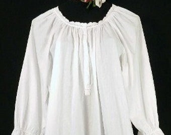 May include: A white cotton nightgown with long sleeves and a gathered neckline. The sleeves have lace trim and the neckline has a lace trim.