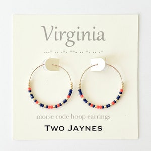 May include: Gold hoop earrings with navy blue and coral beads. The earrings are on a white card with the text "Virginia" and "morse code hoop earrings TWO JAYNES".