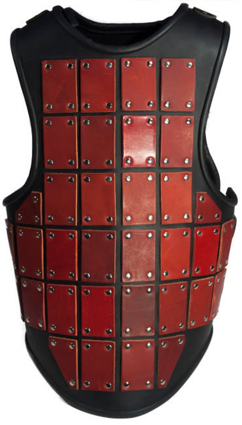 May include: A red leather vest with a black leather backing and metal rivets. The vest is made up of rectangular leather panels.