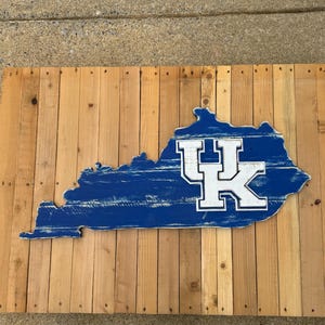 University of Kentucky blue-colored state of Kentucky wood pallet sign; White, blue, white UK stacked Kentucky logo in the center. Wildcats!