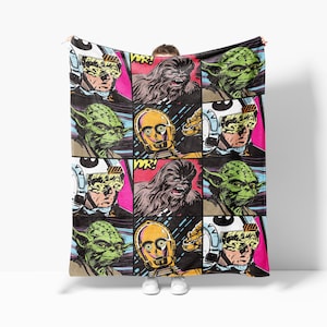 a woman is holding a blanket with comic covers on it