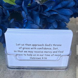 May include: White card with a black text quote from the Bible, Hebrews 4:16, "Let us then approach God's throne of grace with confidence, Dot, so that we may receive mercy and find grace to help us in our time of need."