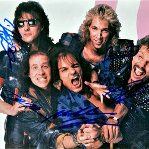 May include: A group of five men in a band pose for a photo. They are all wearing leather jackets and have long hair. The man in the center is wearing a leopard print shirt and has his mouth open in a scream. The man on the left is wearing sunglasses and has his arm around the man in the center. The man on the right is wearing a studded leather jacket and has a mustache. The men are all smiling and looking at the camera.