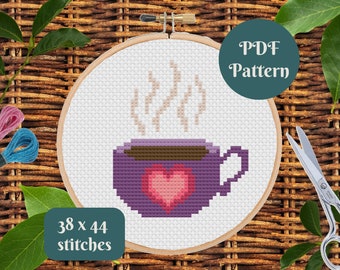 May include: A cross stitch pattern for a purple coffee mug with a heart and steam coming from the top. The pattern is 38 x 44 stitches and is available as a PDF download.