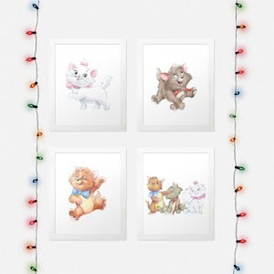 May include: Four framed prints featuring cartoon cats from the Disney movie The Aristocats. The prints are arranged in a grid of two rows and two columns. The top left print shows a white cat with a pink bow and a pink collar. The top right print shows a brown cat with a red collar. The bottom left print shows a brown cat with a blue bow tie. The bottom right print shows three cats: a brown cat with a red collar, a brown cat with a blue collar, and a white cat with a pink bow and a pink collar.