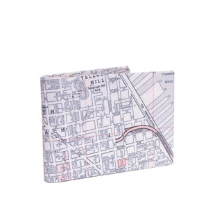 May include: A white and pink map of Telegraph Hill in San Francisco, California, printed on a leather wallet. The wallet is folded in half and the map is visible on the front.