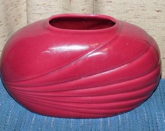 A Vintage Cranberry Color Shell Shaped Vase. A Glossy Ceramic Flower Pot For Real or Artificial Plants or Flowers