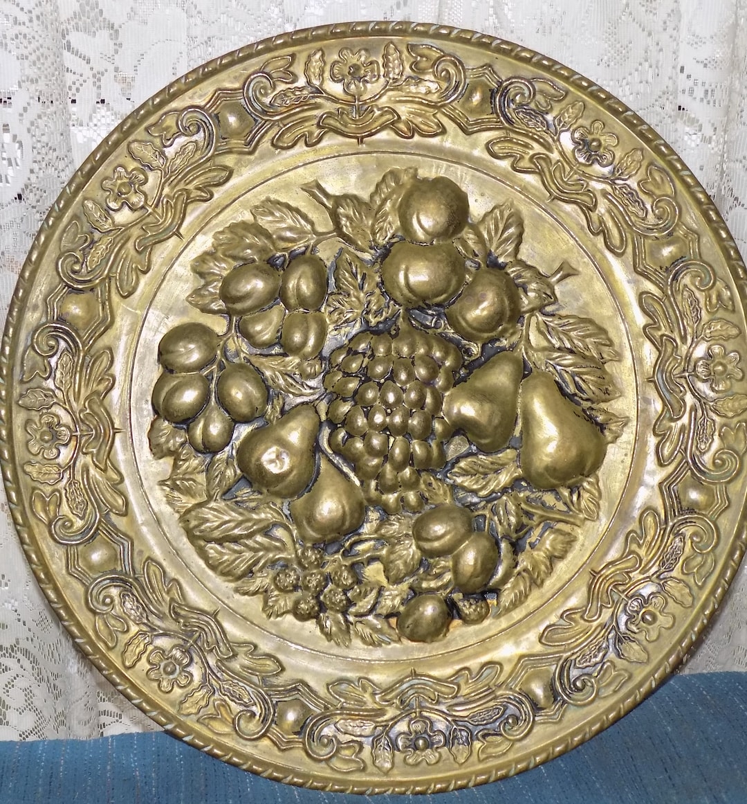 A Vintage Embossed Brass Wall Plate W/a Assorted Fruit Design. 16.5dia