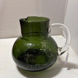 May include: A set of three ceramic mugs with a speckled, matte finish. Each mug features a different color: light blue, cream, and gray. The mugs have a simple, modern design and a comfortable handle.
