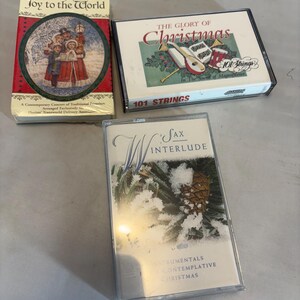 May include: Three vintage Christmas cassette tapes. One tape is red and features a winter scene with the text "Joy to the World." Another is white with "The Glory of Christmas" and "101 Strings." The third is white with "Sax Interlude."