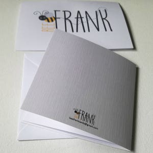 May include: Greeting cards with a bee theme. The top card has the word "FRANK" with a bee graphic and the word "BEE" in yellow. The bottom card is gray with a textured pattern and the words "FRANK" and "beefrankcards@gmail.com".