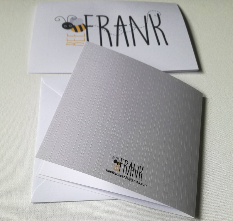 May include: Greeting cards with a bee theme. The top card has the word "FRANK" with a bee graphic and the word "BEE" in yellow. The bottom card is gray with a textured pattern and the words "FRANK" and "beefrankcards@gmail.com".