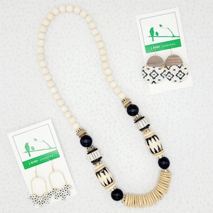 Statement neutral necklace and bracelet with black and white African bone beads and natural accents; ivory and leather earrings
