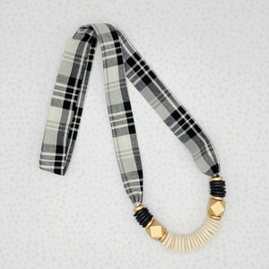 Black and ivory plaid fabric necklace with black and ivory discs and gold accents