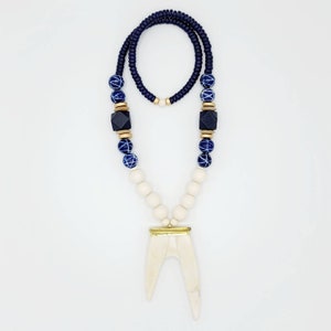 Ivory antler necklace with navy and gold accents and stone blue and white beads.