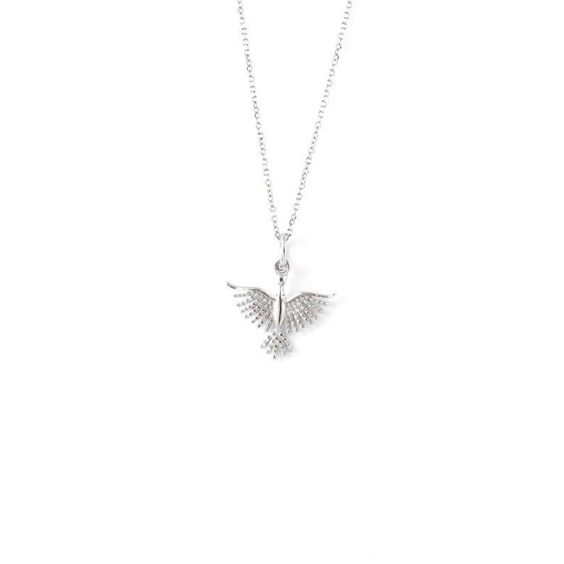 May include: A silver necklace with a delicate bird pendant. The bird has detailed wings and a small body.