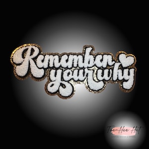 May include: White felt patch with gold glitter trim and black outline. The patch says "Remember your why" with a small heart after "why".