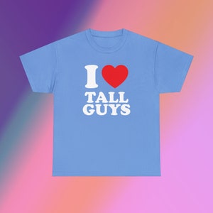 May include: A light blue t-shirt with the text "I ♥ TALL GUYS" in white letters with a red heart.