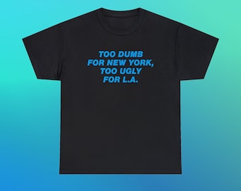Camiseta unissex de algodão pesado com a frase "Muito burro para Nova York, muito feio para Los Angeles". Presente divertido com slogan moderno e icônico de Nova York, LAX e Los Angeles.
