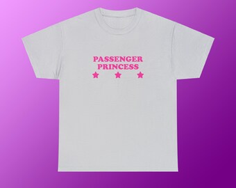 May include: A light gray t-shirt with the text "PASSENGER PRINCESS" in pink lettering and three pink stars.