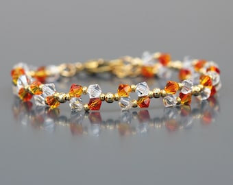 Bracelet Cristal orange pour Femme. Perles bicônes et Perles rondes acier inox doré. Apprêts inox doré.