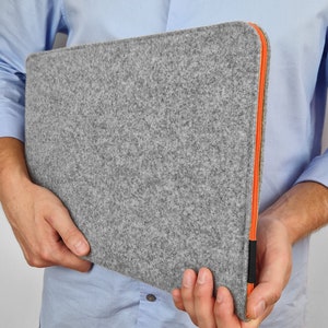 Grey felt MacBook cover with orange zipper. Hand made case for MacBook air 13 inch, MacBook air 15 inch, and any other. Case opens on the top and side to easly fit in the laptop.