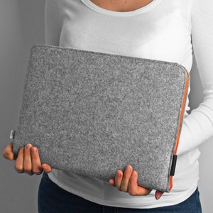 Grey felt MacBook cover with orange zipper. Hand made case for MacBook air 13 inch, MacBook air 15 inch, and any other. Case opens on the top and side to easly fit in the laptop.