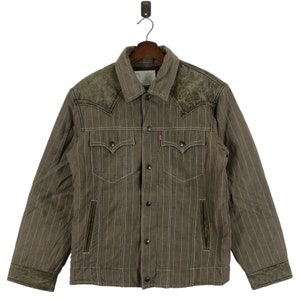 May include: A brown and white striped denim jacket with leather accents on the shoulders and cuffs. The jacket has a button-up front and two chest pockets.