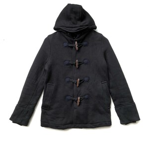 May include: A black hooded sweater with a toggle closure and a fleece lining. The sweater has two pockets on the front and a navy blue trim.