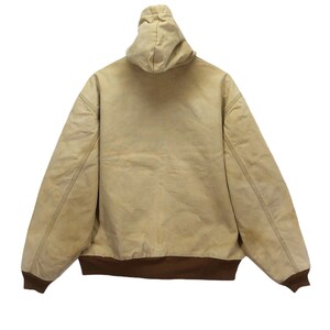 May include: A tan hooded jacket with a brown ribbed waistband. The jacket is made of a thick, durable fabric.