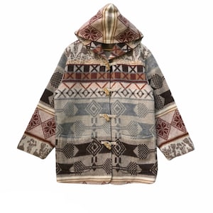 May include: A hooded wool coat with a geometric pattern in shades of brown, gray, and cream. The coat features wooden toggle closures and two front pockets. The design includes various shapes and patterns.