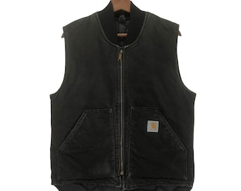 May include: A black quilted Carhartt work vest with a zipper closure and a Carhartt logo patch on the front.