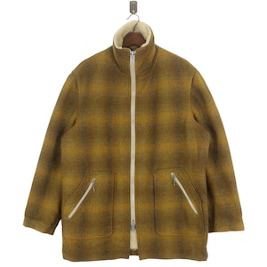 May include: A brown and yellow plaid jacket with a zipper closure and a sherpa lining. The jacket has two zippered pockets on the front.
