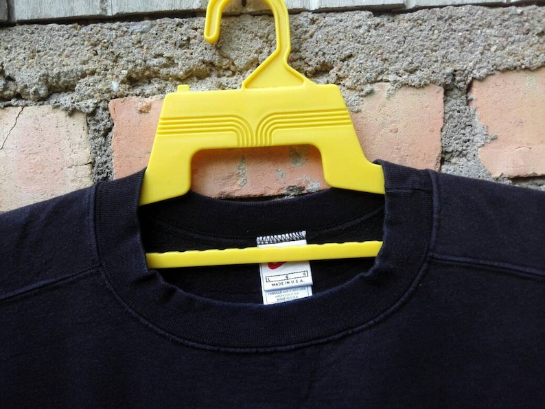 May include: Black crew neck t-shirt with a white tag that reads "L" and "Made in U.S.A."