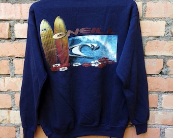 May include: A navy blue long-sleeved sweatshirt with a graphic print of two surfboards and a wave. The text "ONEILL" is printed on the sweatshirt.