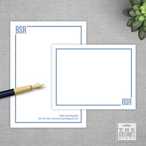 May include: White stationery set with blue border and initials "BSR". Includes a notepad and a smaller card. A black and gold pen rests on the gray surface. The Gentleman's Study logo is in the bottom right corner.