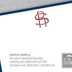 May include: A display sample of a stationery set with a red monogram of the letters "RS" in a decorative font. The text "DISPLAY SAMPLE:" is written in black, followed by the text "Ink colors: Admiral & Carnelian", "Lettering style: MON 114 & LET 202", and "Envelope Liner: Solid Color / Carnelian ink". The text "THE GENTLEMAN'S STUDY" is written in black with a gray background and a gray mustache graphic.