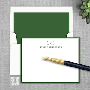 May include: A white card with a green border and a green envelope. The card has a crossed golf club logo and the text "HENRY RUTHERFORD".