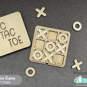 May include: A wooden Tic Tac Toe game with a board, nine playing pieces, and a separate sign that reads "Tic Tac Toe". The game is made of natural wood and has a rustic look.