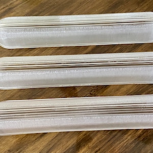 May include: Three white frosted glass light fixture covers with a ribbed texture.