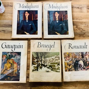 May include: Five vintage hardcover books featuring famous artists, including Gauguin, Modigliani, Bruegel, Rouault. Each book has a colorful image of a painting on the cover.