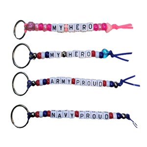 May include: Four keychains with red, white, and blue beads and letter beads spelling out "My Hero", "My Hero", "Army Proud", and "Navy Proud".