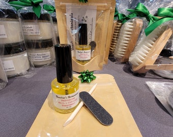 restoring nail and cuticle treatment oil kit in a giftable pouch with mini nail file and wooden orange stick cuticle pusher