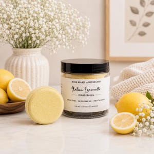 May include: A clear plastic jar with a black lid containing three yellow bath bombs, labeled Rose Marie Apothecary Italian Limoncello, net wt. 5 oz each (15 oz total). A single yellow bath bomb sits in front of the jar, surrounded by fresh lemons.