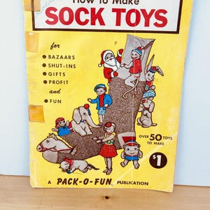 May include: A white ceramic mug with a black handle and the text "But First, Coffee" in a handwritten style. The mug is on a white surface. The mug is 10 cm tall.